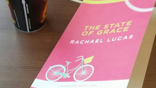 proof copy of the state of grace by rachael lucas next to a cup of coffee