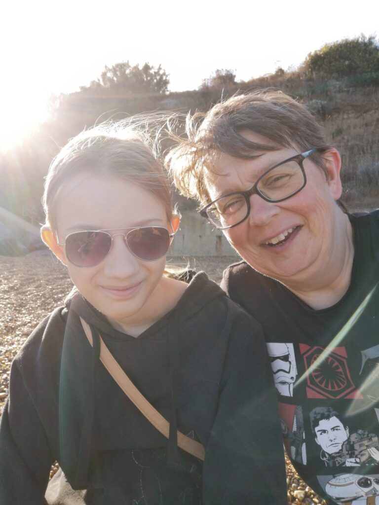 Selfie shot of me and Smallest on beach, smiling into camera