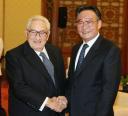 Former US Secretary of State Henry Kissinger, left, shakes hands with Wu Bangguo, chairman of the Standing Committee of the National People