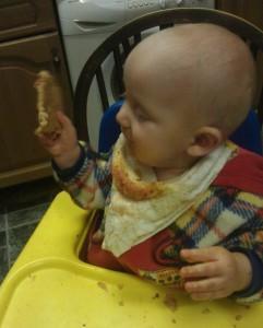 baby with pizza