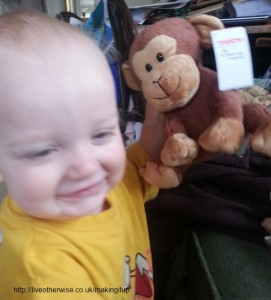 baby with cuddly toy monkey