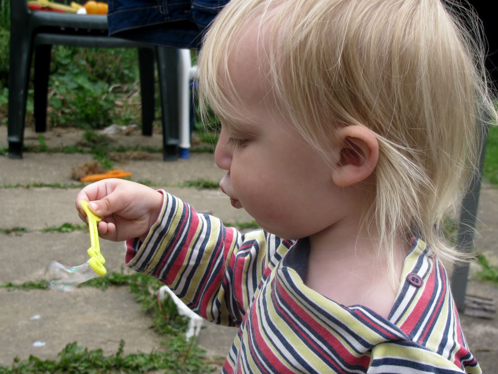 boy blowing bubbles